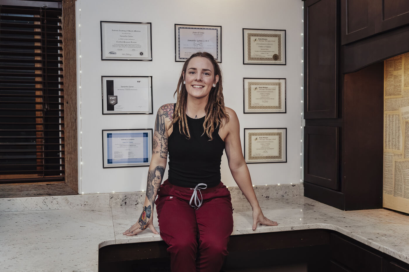 Sammi at the studio with her certifications