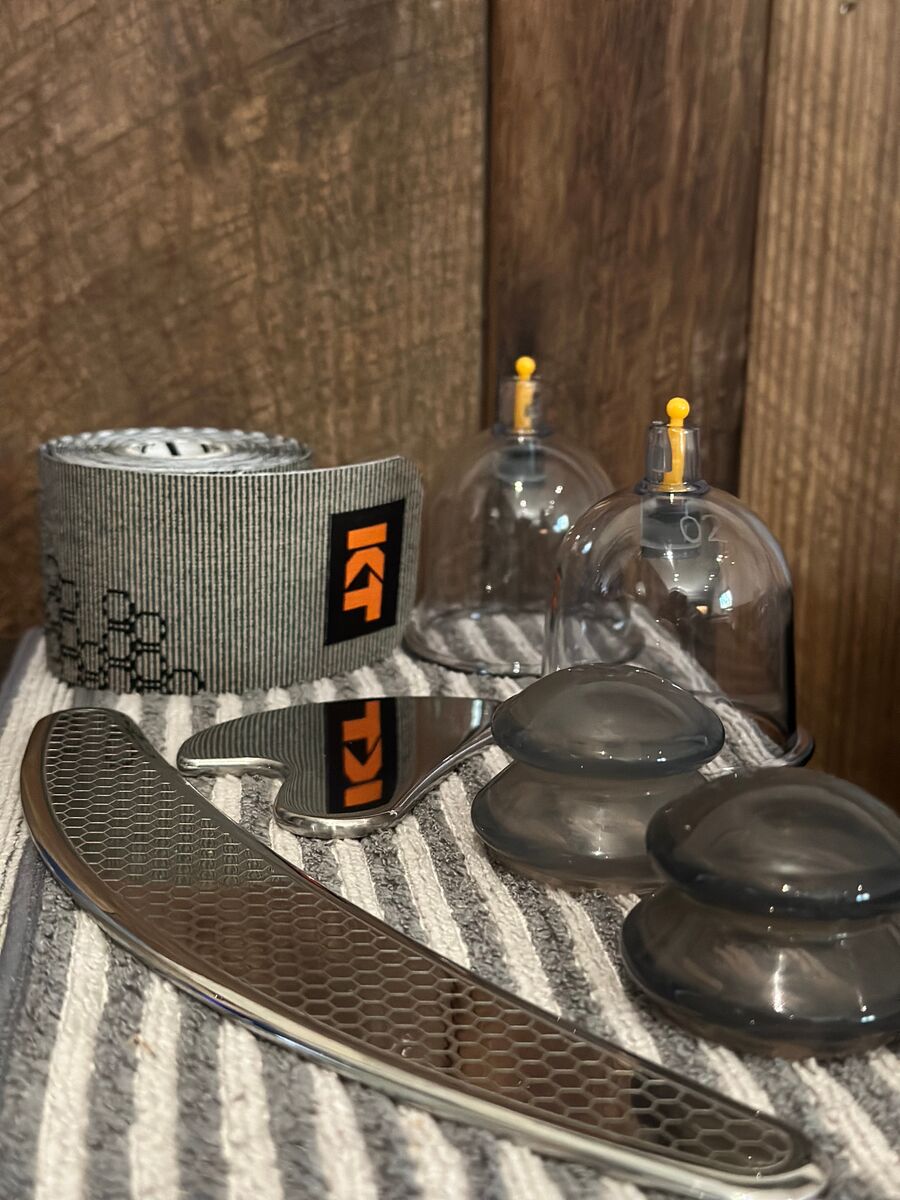 Cupping sets, scraping tools, and kinesiology tape at the studio
